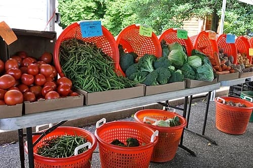 A small, soft photo of vegetables at a market stall